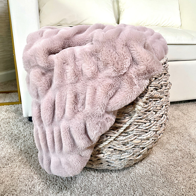 Cloud9 blush faux fur blanket draped on a surface, 30x40 inch lap size, soft and plush fabric for cozy comfort.