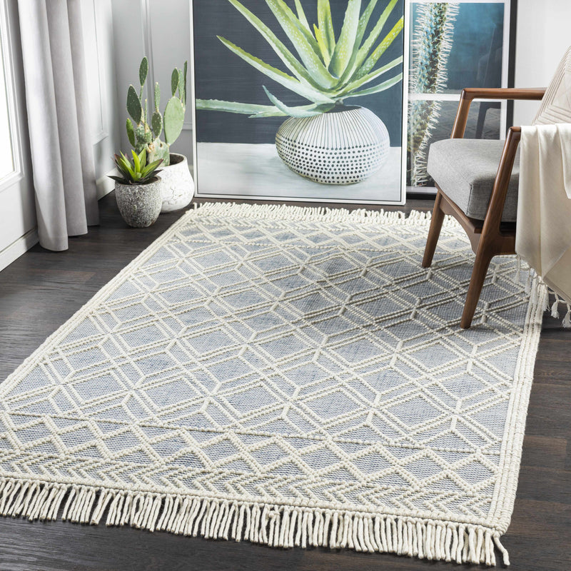 Hauteloom Ramsbury Ivory and Blue area rug featuring intricate patterns, displayed in a stylish living room setting.
