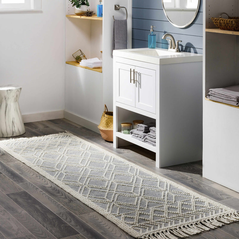 Hauteloom Ramsbury Ivory and Blue area rug in a living room setting, featuring intricate patterns and a soft textured surface.