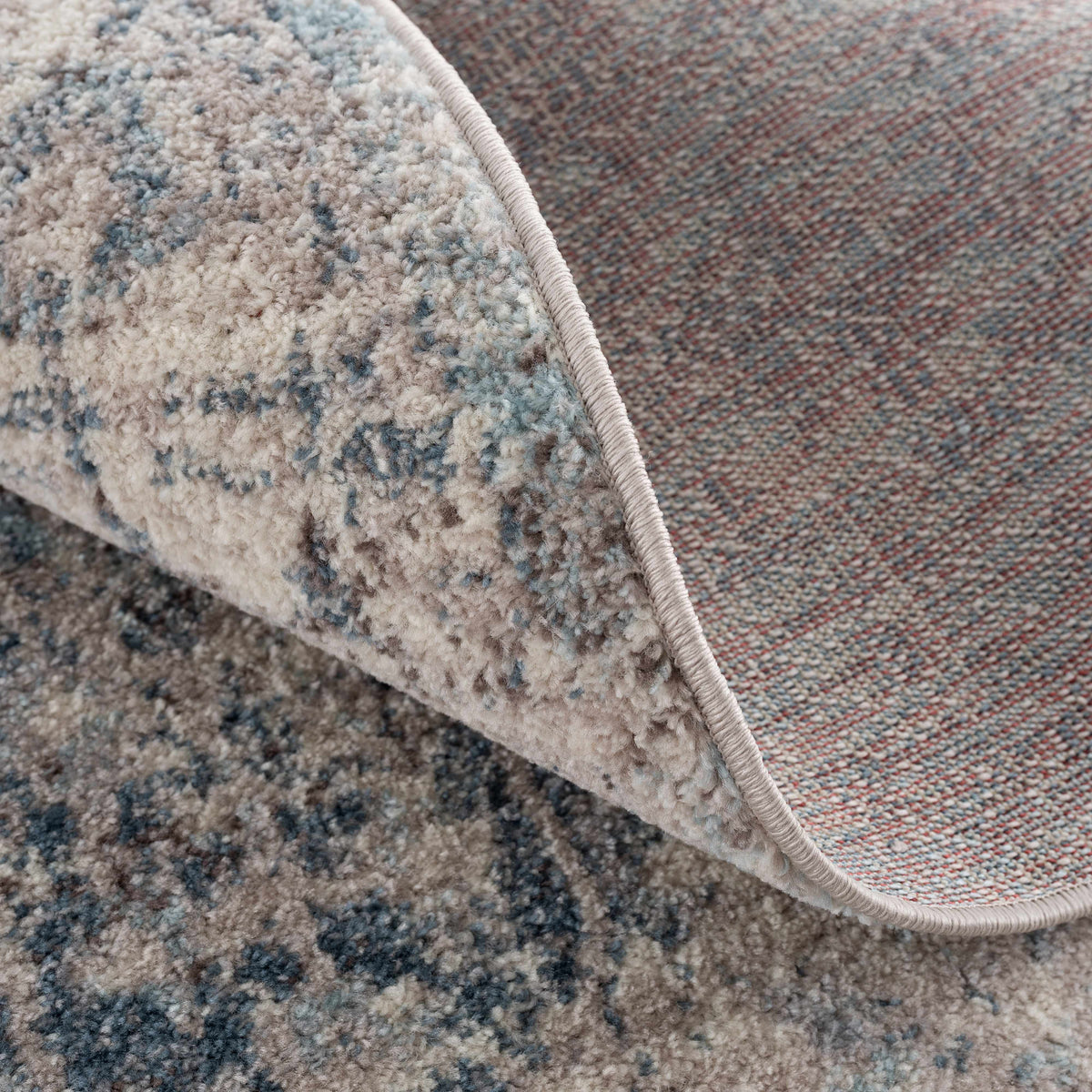 Hauteloom Orrick area rug with a folded design in rich red tones, showcasing intricate patterns and soft texture.