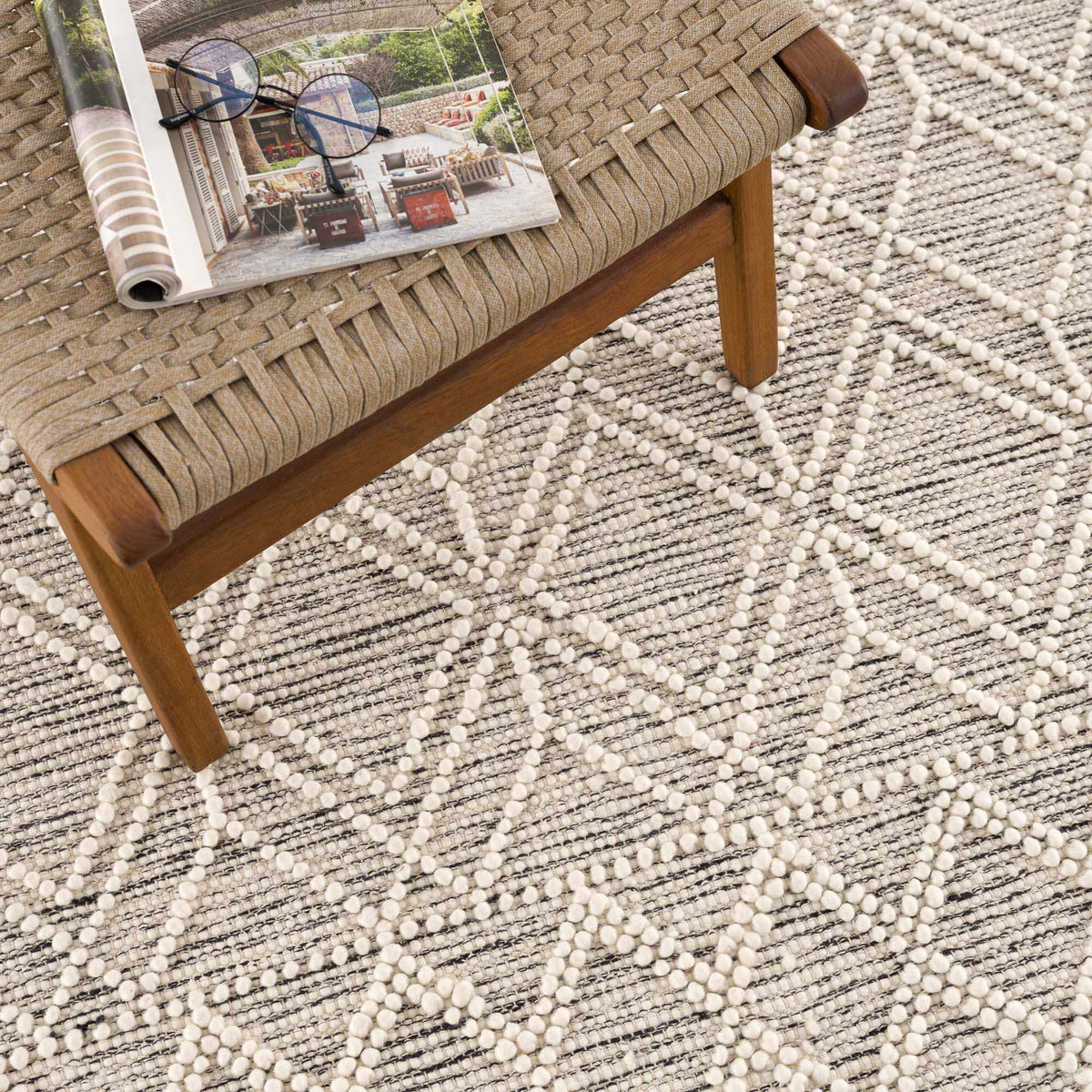 Hauteloom Ramsbury area rug featuring a modern geometric pattern in neutral tones, displayed on a hardwood floor.