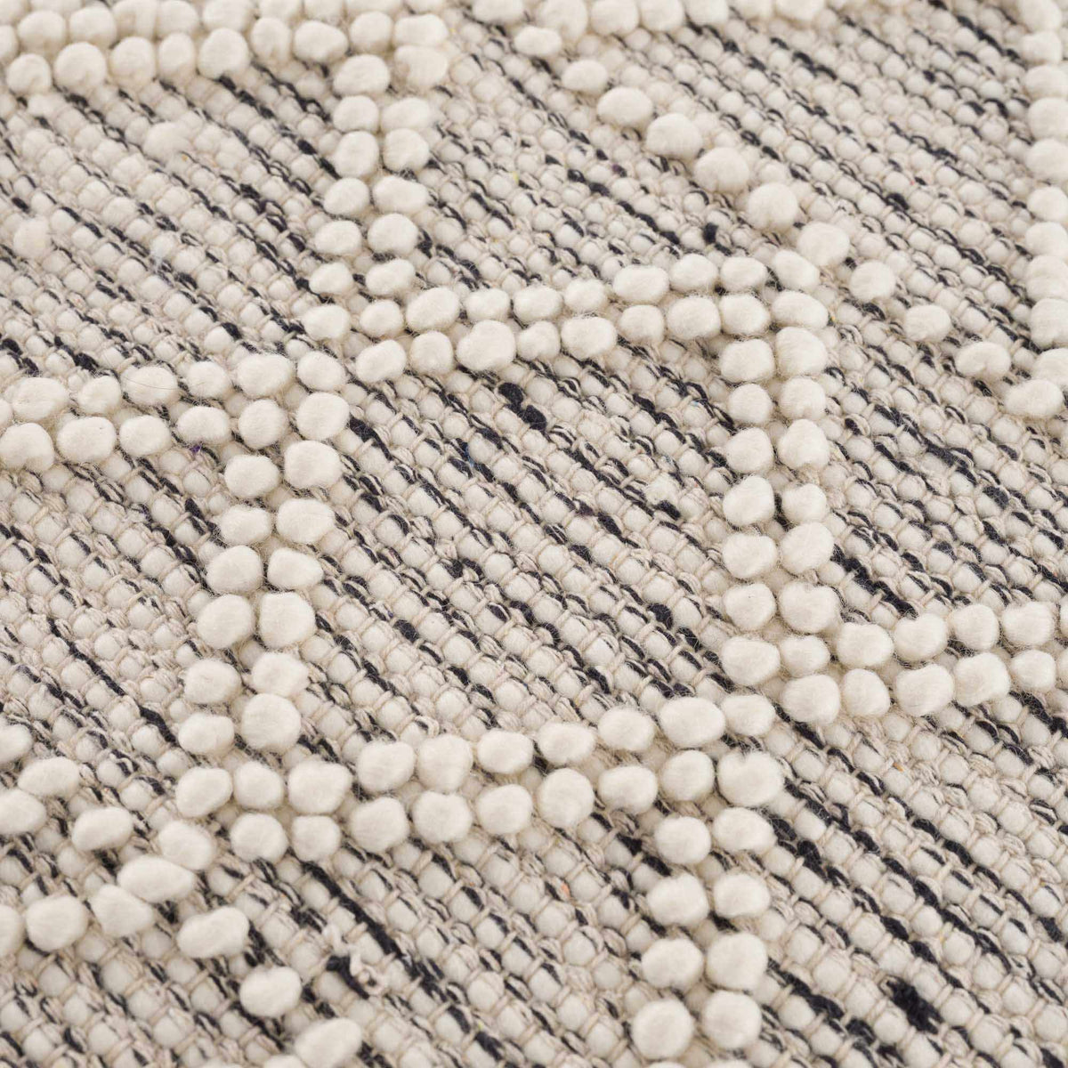 Hauteloom Ramsbury area rug with textured gray and beige pattern, soft and plush surface, ideal for living room or bedroom decor