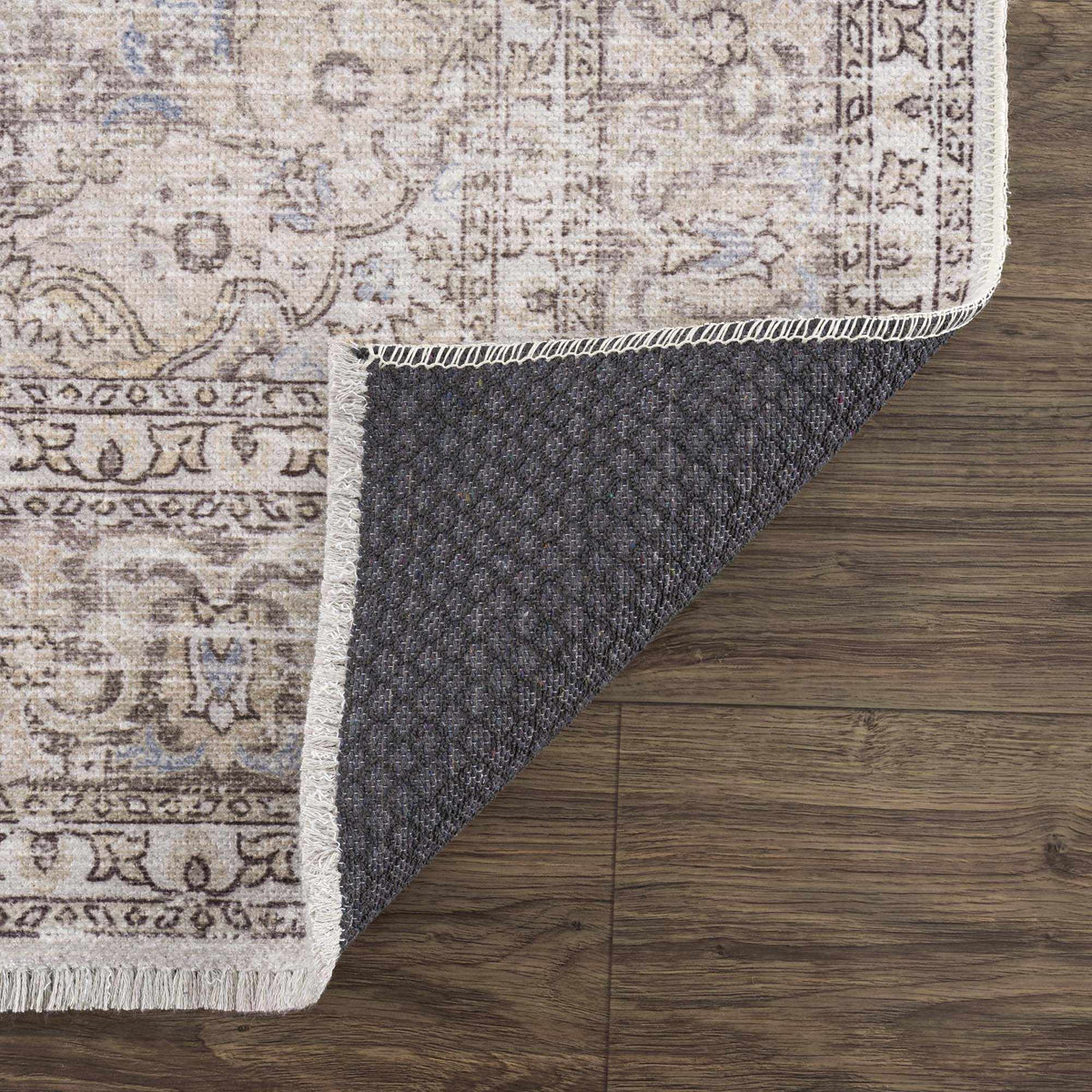 Folded Cream Holi-2301 washable area rug by Hauteloom, featuring soft fabric and intricate pattern, displayed on a studio background.