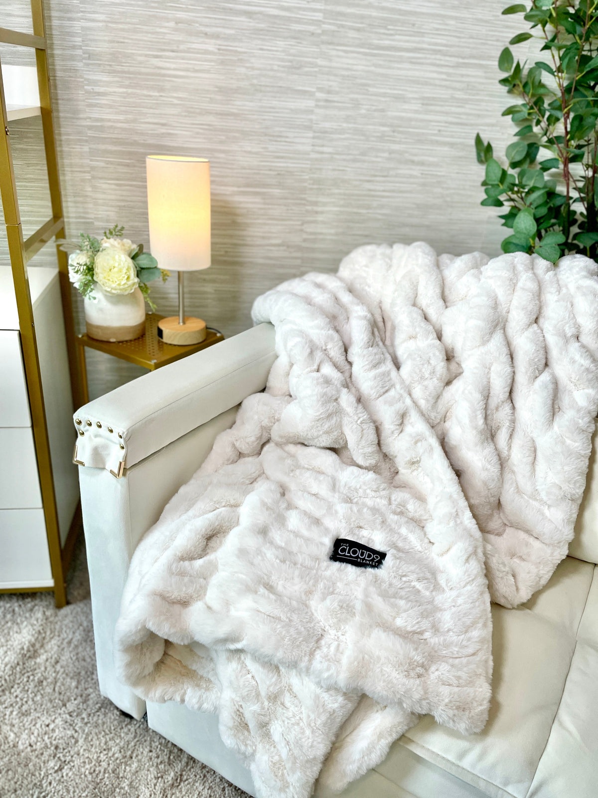 Soft ivory faux fur blanket by Cloud9, medium size 50x60 inches, displayed draped on a cozy bed.