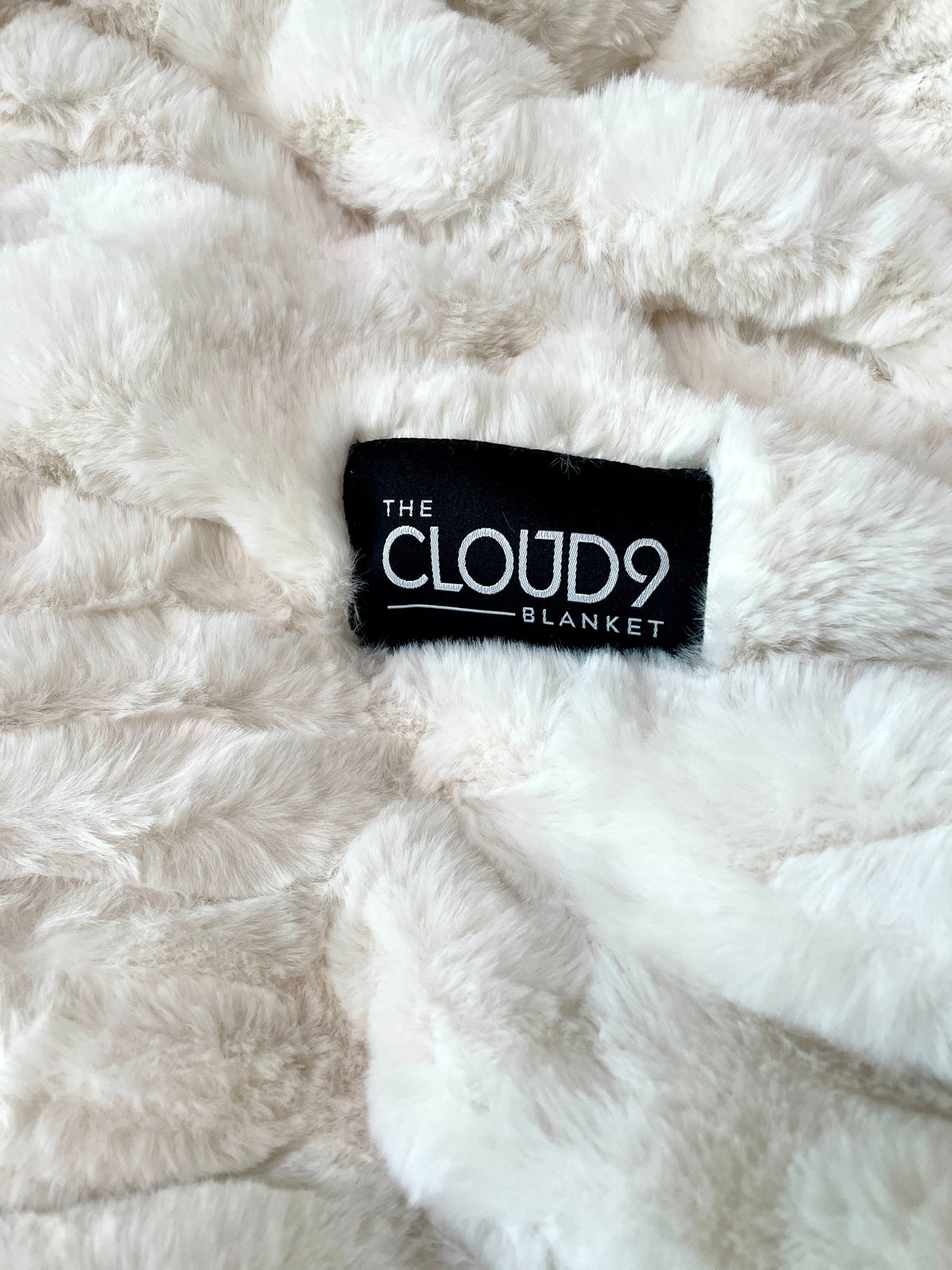 Large ivory faux fur blanket by Cloud9, showing soft, plush fabric and cozy texture, measuring 60x72 inches.