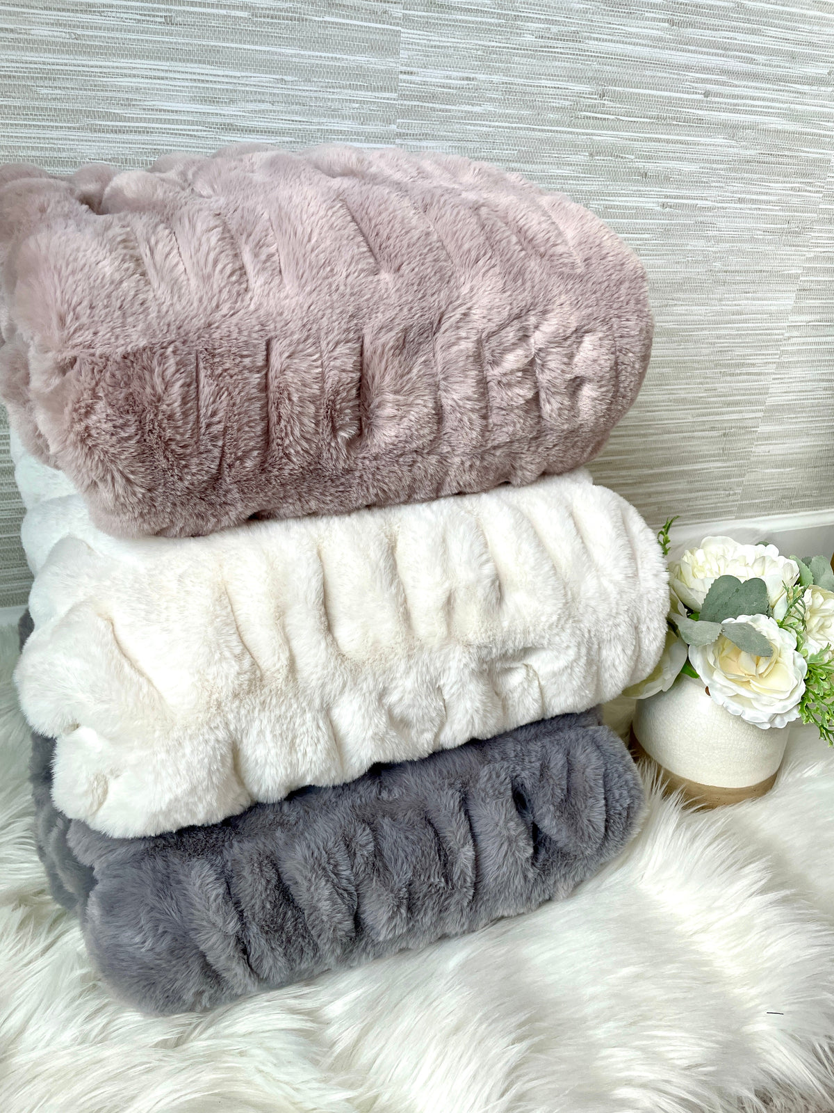 Soft Cloud9 faux fur blanket in medium and large sizes, showcasing plush, cozy texture in a neutral color.