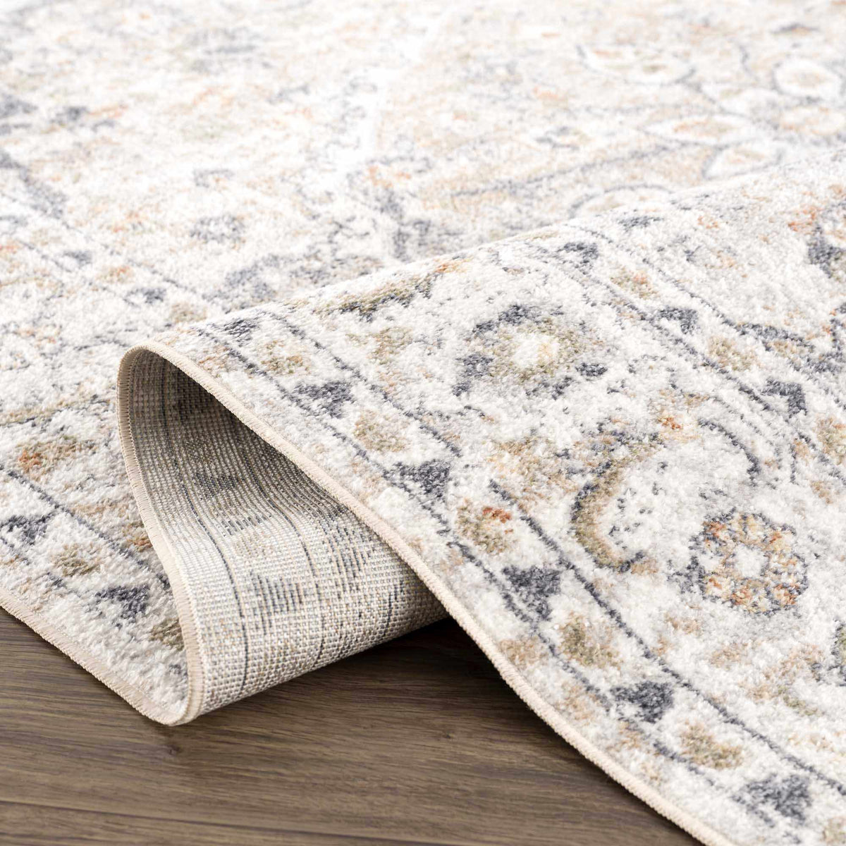 Cream Hauteloom Hiti washable area rug folded to show soft, plush texture and clean cream color, ideal for modern living spaces.