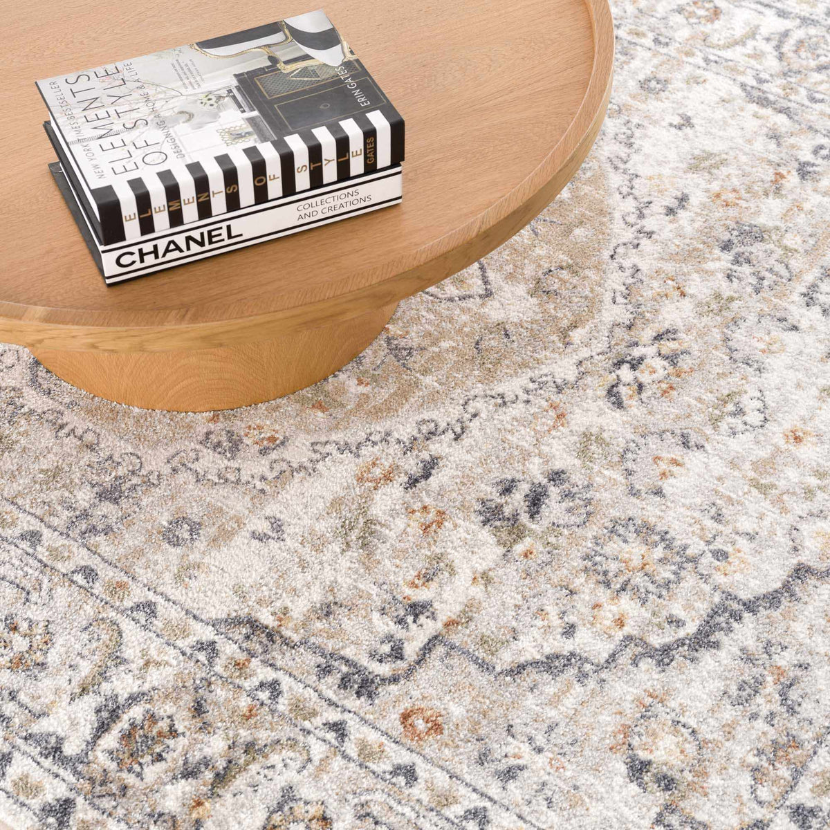 Cream washable area rug by Hauteloom with a subtle textured pattern, shown in a modern interior setting.