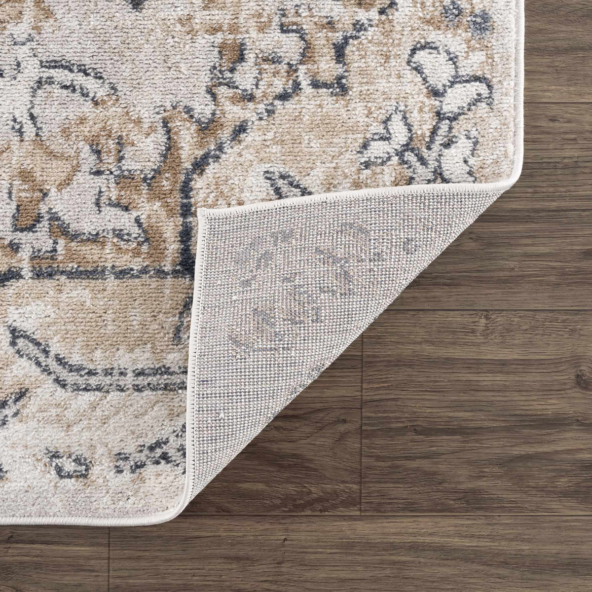 Hauteloom Mudgee Area Rug with folded edge, showcasing intricate patterns and soft texture in a stylish home decor setting.