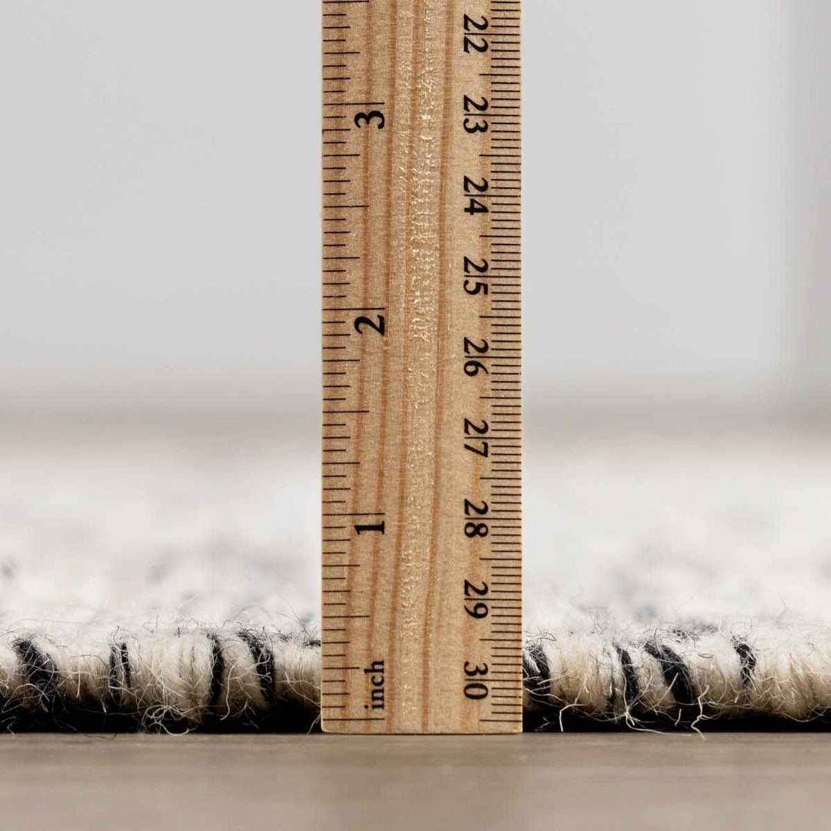 Hauteloom Williford Wool Area Rug with a textured pile in neutral tones, perfect for adding warmth to living spaces.