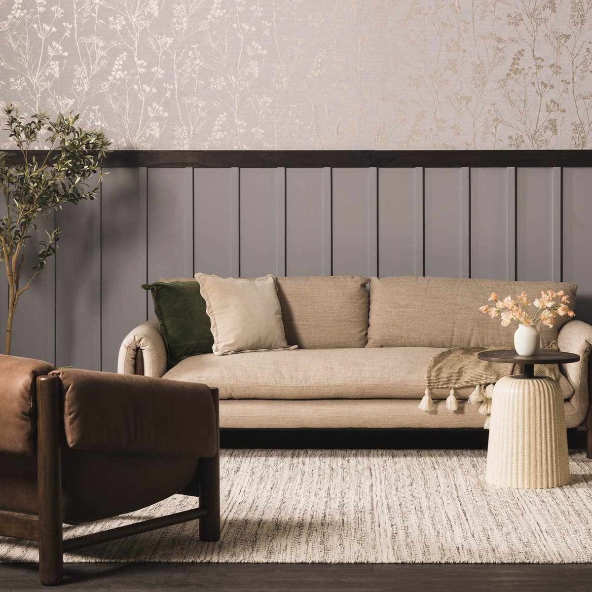 Hauteloom Williford Wool Area Rug in a cozy living room, featuring a soft, textured beige wool rug on wooden flooring.