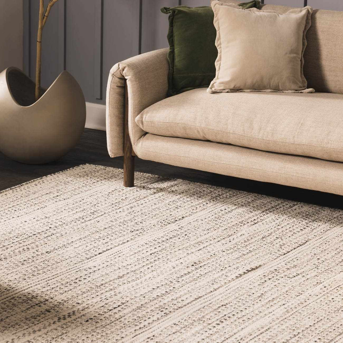 Hauteloom Williford Wool Area Rug in a cozy living room setting with neutral tones and textured pattern on hardwood floor.