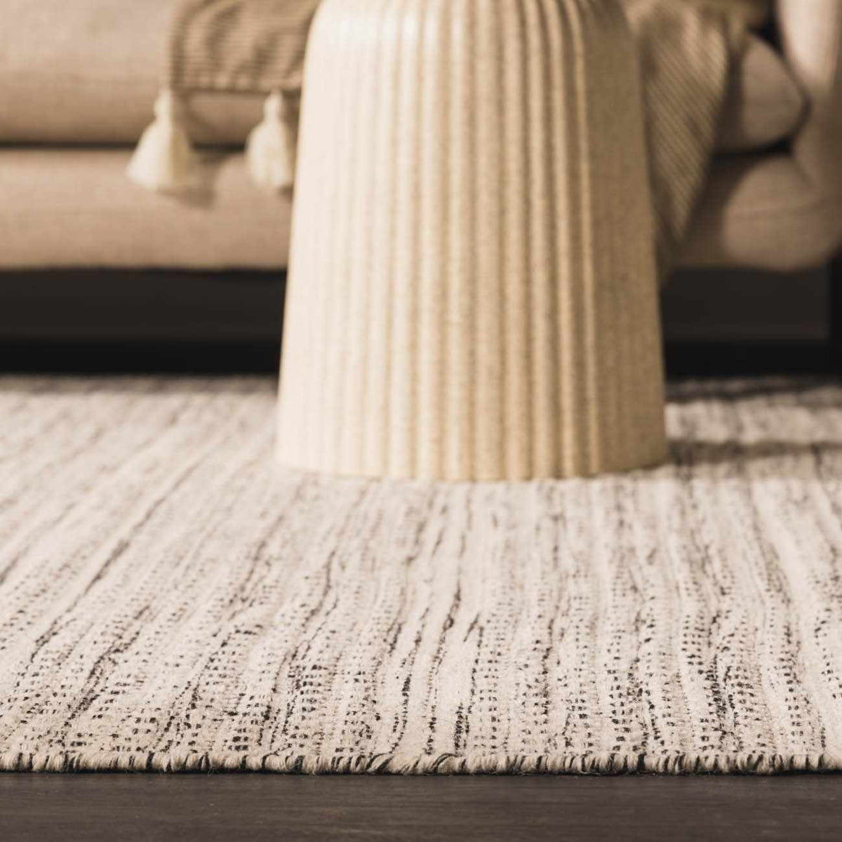 Hauteloom Williford Wool Area Rug in a cozy living room setting, showcasing its textured wool design and neutral tones.