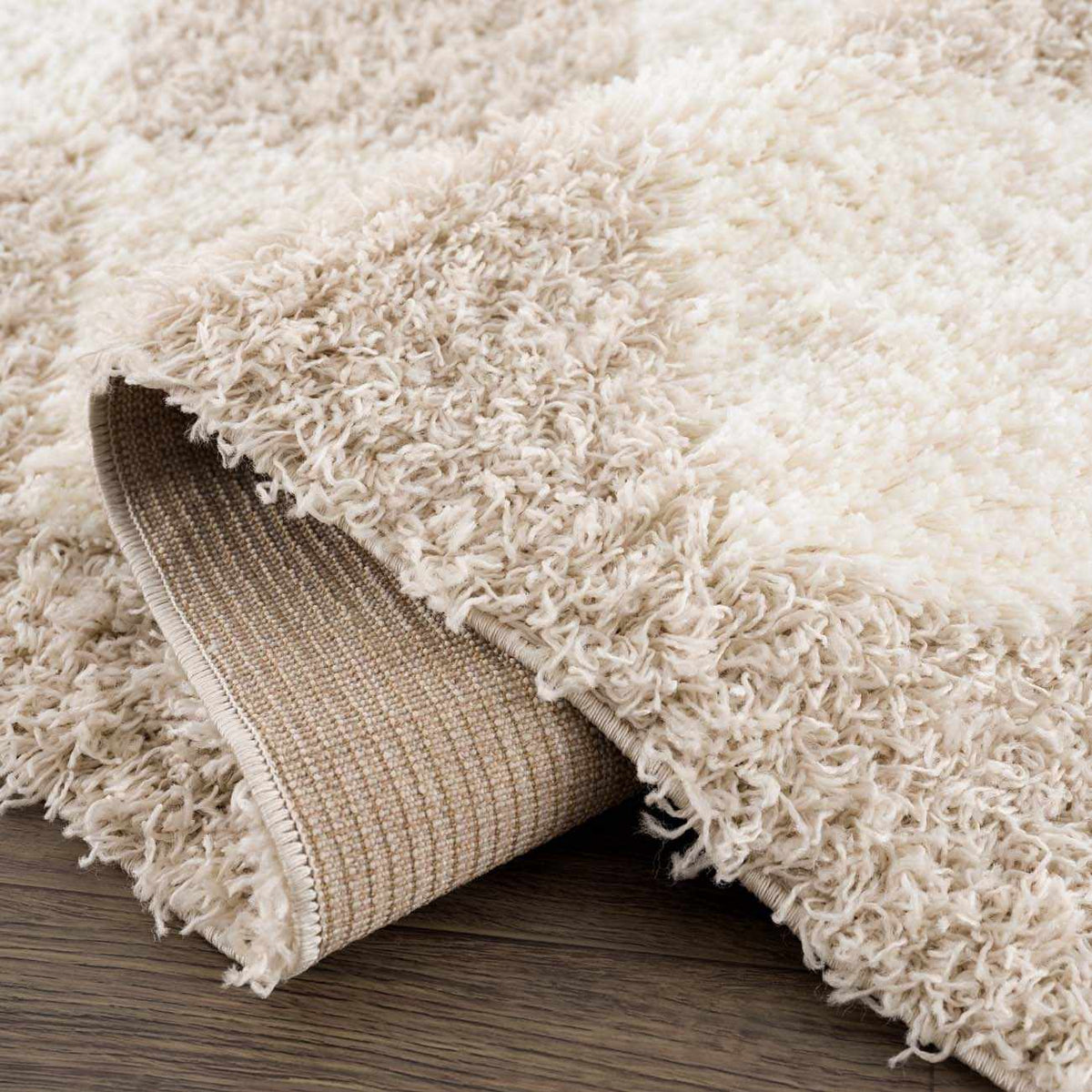 Cream and beige diamond-patterned area rug by Hauteloom, featuring a soft, plush texture and geometric design.