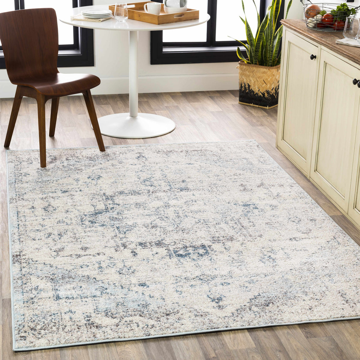 Hauteloom Orrick area rug with geometric pattern in neutral tones, shown in a cozy living room setting.