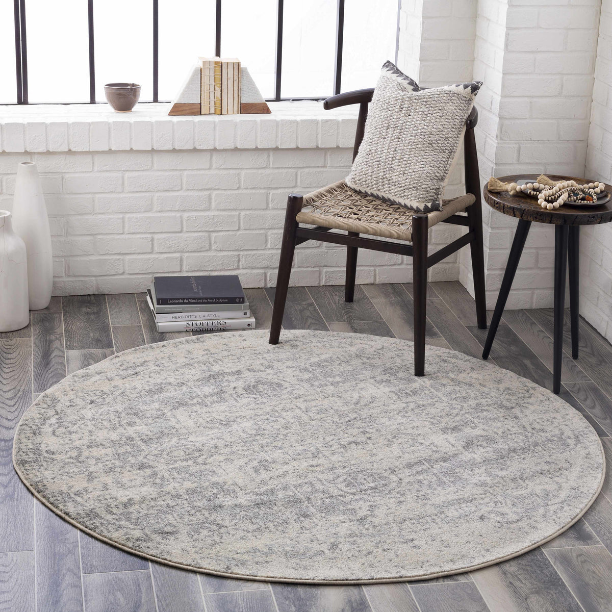Hauteloom Rachel round area rug with intricate geometric pattern on a modern living room floor.