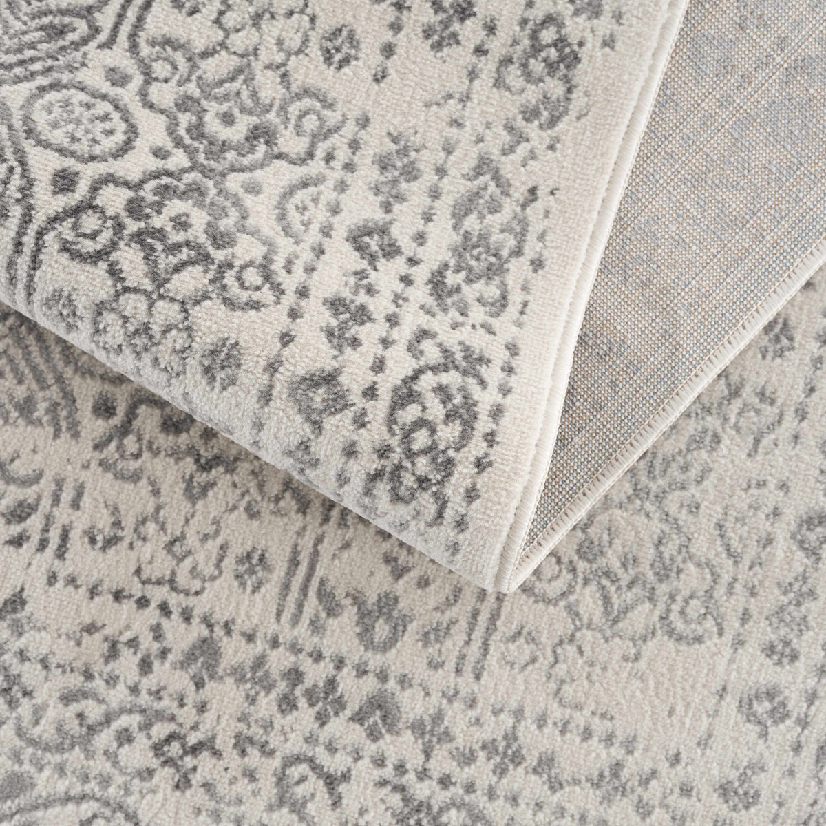 Hauteloom Michie area rug with intricate geometric patterns, soft neutral colors, and a plush texture for modern home decor.