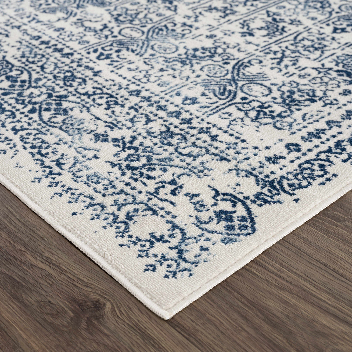 Hauteloom Michie Blue area rug shown in a corner, featuring a textured pattern and vibrant blue color for modern home decor