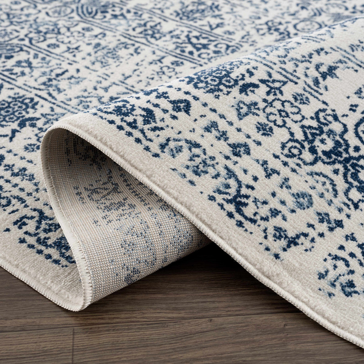 Hauteloom Michie Blue area rug with geometric pattern, soft texture, and vibrant blue color, suitable for modern living rooms.