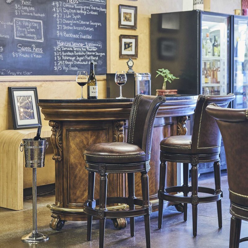 Charlotte Swivel Barstool in distressed walnut wood with a cushioned seat, showcasing a stylish furniture piece by Carolina Barstool.