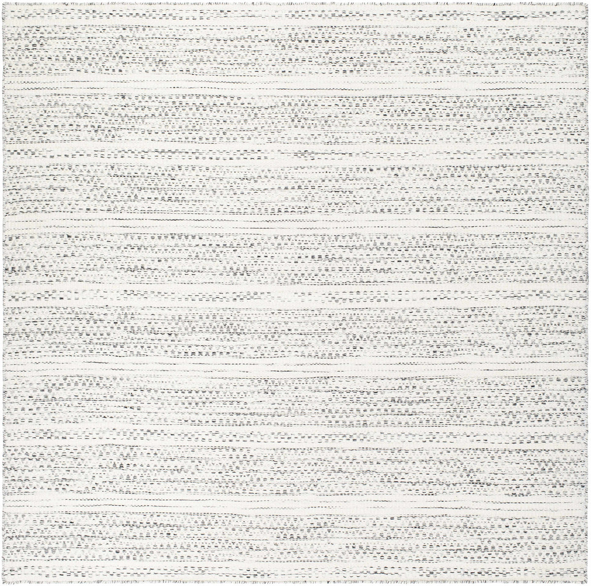 Hauteloom Williford Wool Area Rug with geometric pattern in neutral tones, showcasing soft, textured wool fibers on a flat surface.